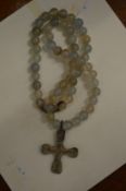 A Roman bronze cross on a bead necklace.