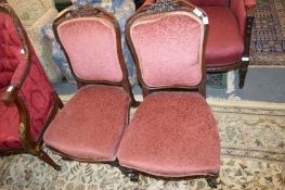 A pair of Victorian carved rosewood framed upholstered bedroom chairs.