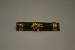 A gold and jade bar brooch.