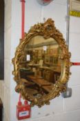 A gilt framed mirror.