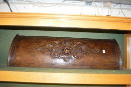 A carved wood bow fronted door or panel.