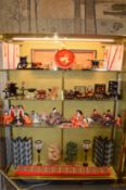 A large and impressive collection of Japanese dolls, modelled as various figures in seated and prone