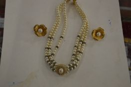 A Christian Dior necklace and a pair of similar flower head ear studs.