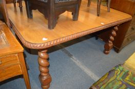 A rosewood extending dining table.