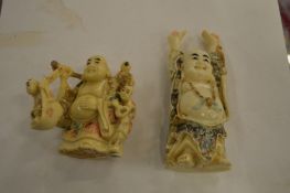 Two carved bone Buddhas.