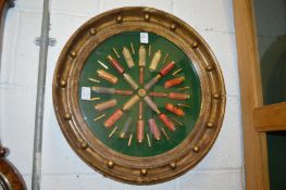 Shooting interest, a collection of early shotgun cartridges and bullets decoratively mounted in a