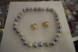 A chunky pearl necklace and earrings.