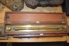 A boxed brass surveying rule.
