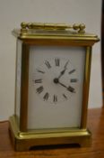 A brass carriage clock.