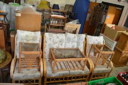 A bamboo conservatory suite comprising a two seater settee, a pair of armchairs and three coffee