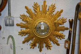 An Elliott Sunburst wall clock.