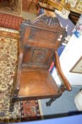 A 17th century style carved oak armchair.