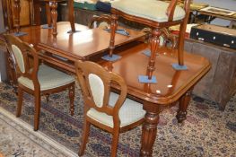 A good Victorian style mahogany extending dining table with two leaves.