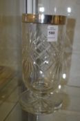 A cut glass celery vase withsilver rim.