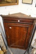 A 19th century oak hanging corner cupboard.