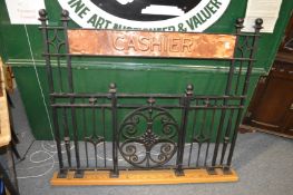 An unusual wrought iron and copper cashier's screen.