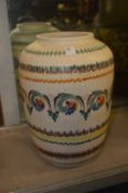A large colourful pottery vase.