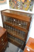 An oak Globe Wernicke three section bookcase with a drawer to the base.