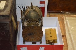 A small lantern clock with later battery movement (original movement also included).