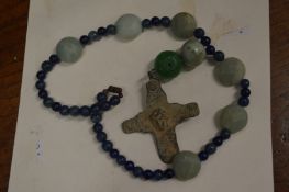 A Roman bronze cross on a bead necklace.