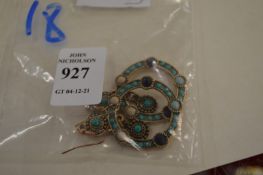 A pair of turquoise set hoop earrings.