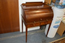 An Edwardian inlaid mahogany cylinder bureau.