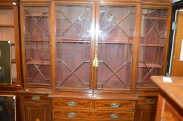 A George III style mahogany and satinwood inlaid breakfront library bookcase.