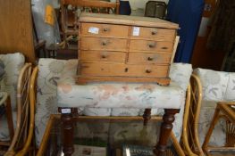 A small pine table top chest and a stool.