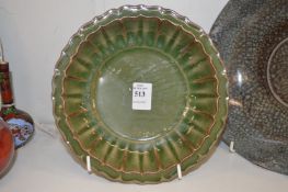 A Chinese green glazed ribbed bowl.