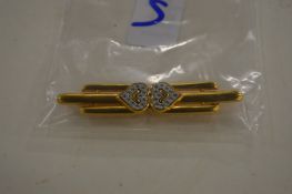 A decorative bar brooch, signed Monet.
