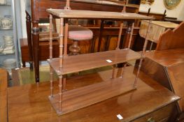 A set of wall shelves with faux bamboo spindle supports.