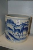 A large Chinese blue and white brush pot painted with deer in a landscape.