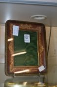 A gilt embossed leather photograph frame.