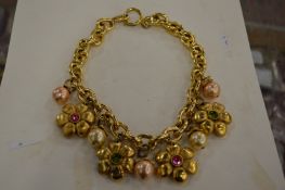 A designer necklace with flower head motifs.