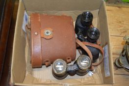 Two pairs of binoculars.