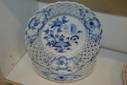 A pair of Meissen blue and white small plates with pierced borders.