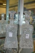 A pair of cut glass decanters.