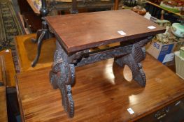 A carved hardwood stool.