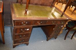 A reproduction mahogany pedestal desk.