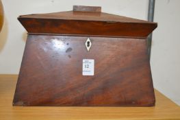 A mahogany sarcophagus shaped tea caddy.