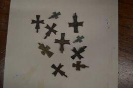 A collection of small Roman bronze crosses.