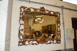 A decorative Florentine framed wall mirror.