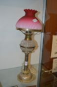An oil lamp with plated base (converted to electricity).