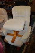 A modern beige cloth upholstered reclining revolving armchair with matching stool.