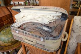 A suitcase containing curtains.