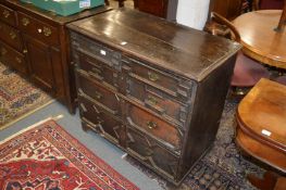 An 18th century oak chest of drawers comprising two short and three long drawers with geometric