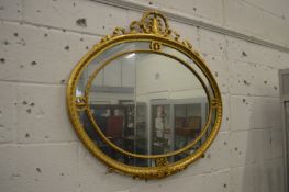 A good decorative oval gilt framed wall mirror.