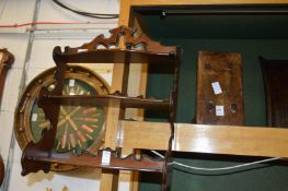 A small stool, wall shelves, a beer or powder keg and a large jug.