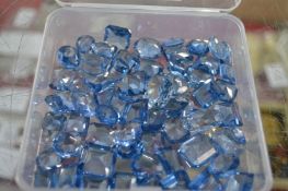 A quantity of sapphire coloured stones.