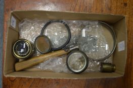 A large magnifying glass and other optical equipment.